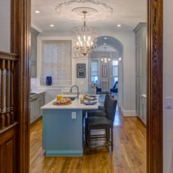 Kitchen with large pendant light and island