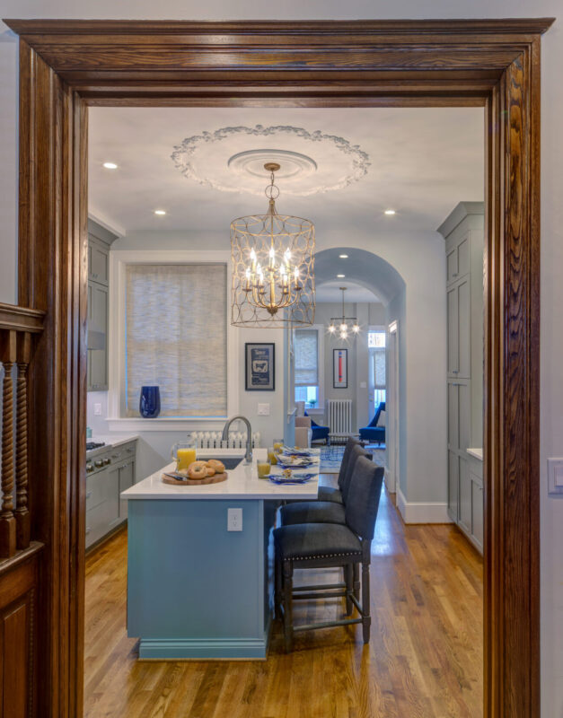 Kitchen with large pendant light and island